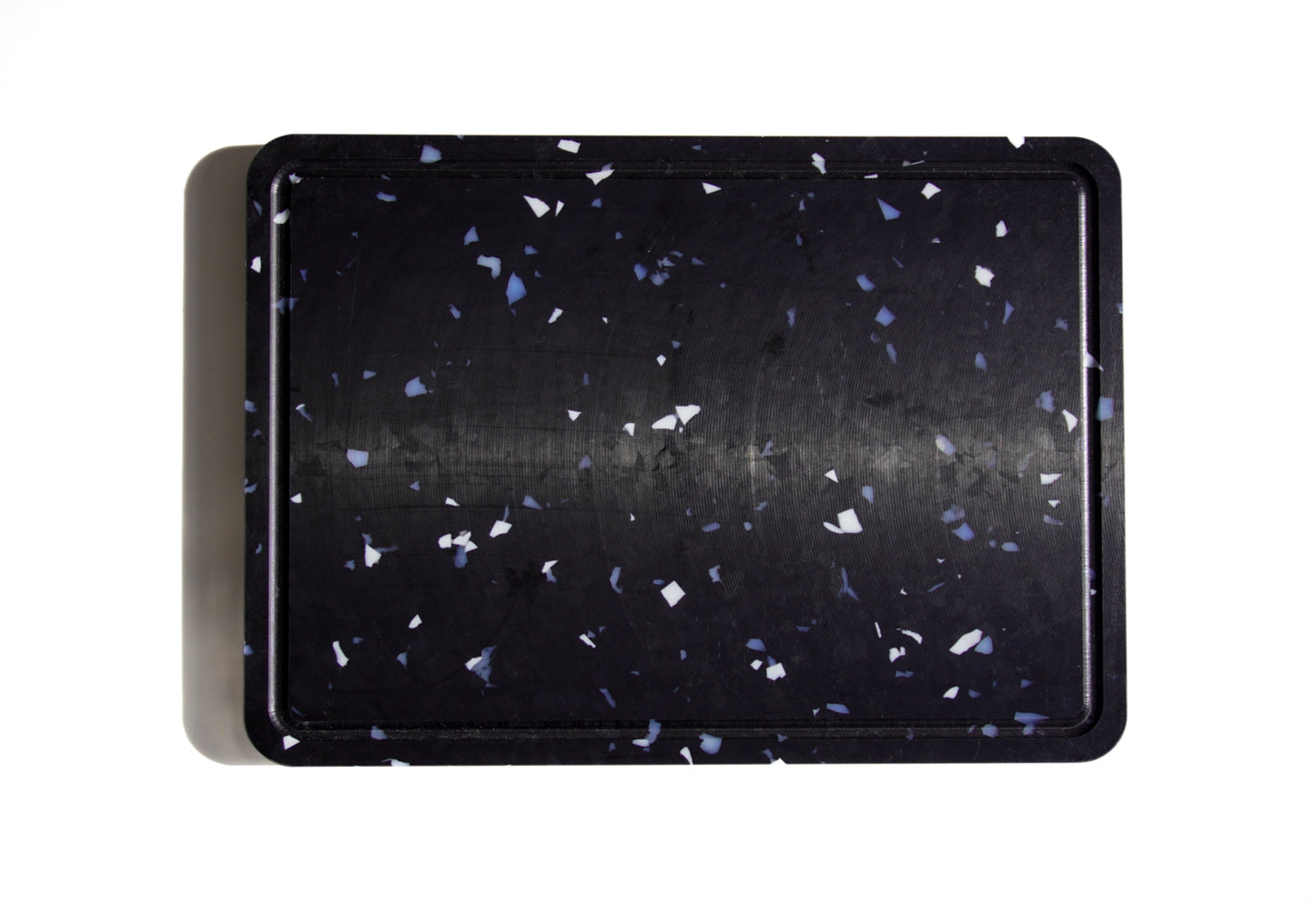 Black chopping board with white and grey speckles