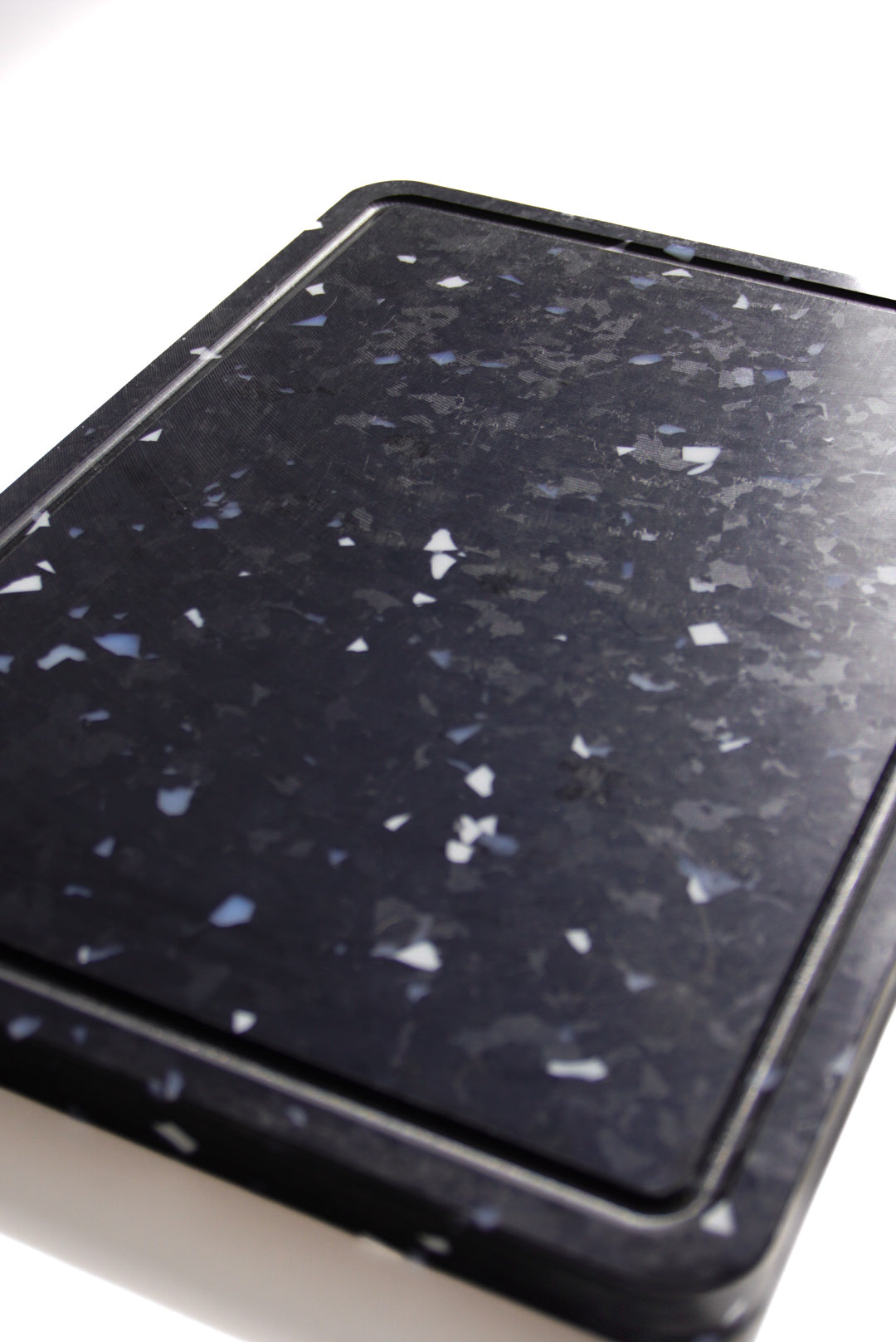 Black chopping board with white and grey speckles