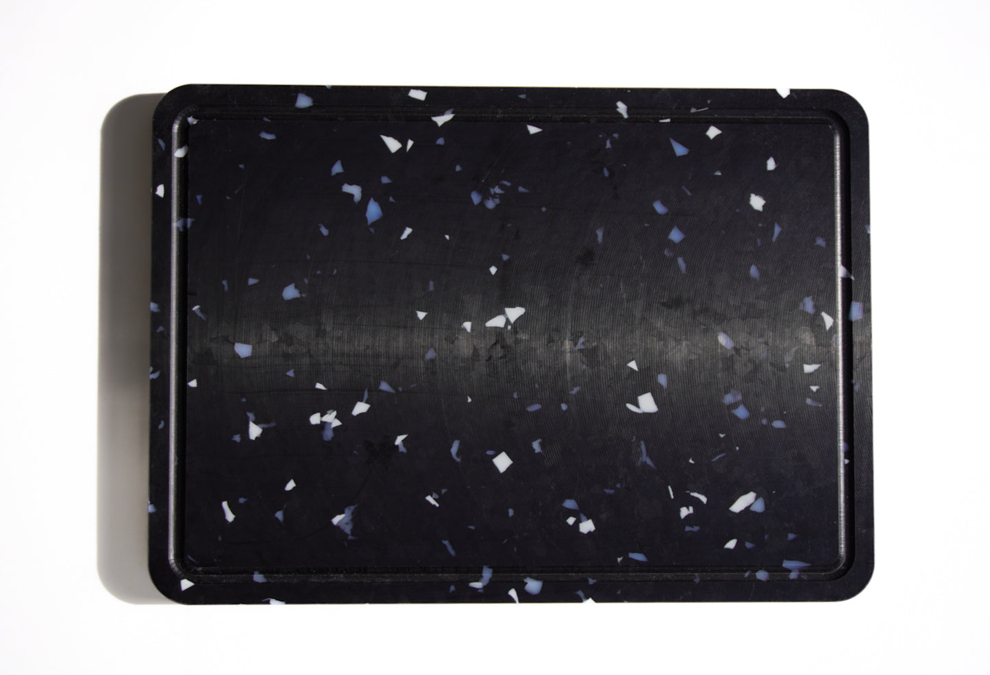 Black chopping board with white and grey speckles