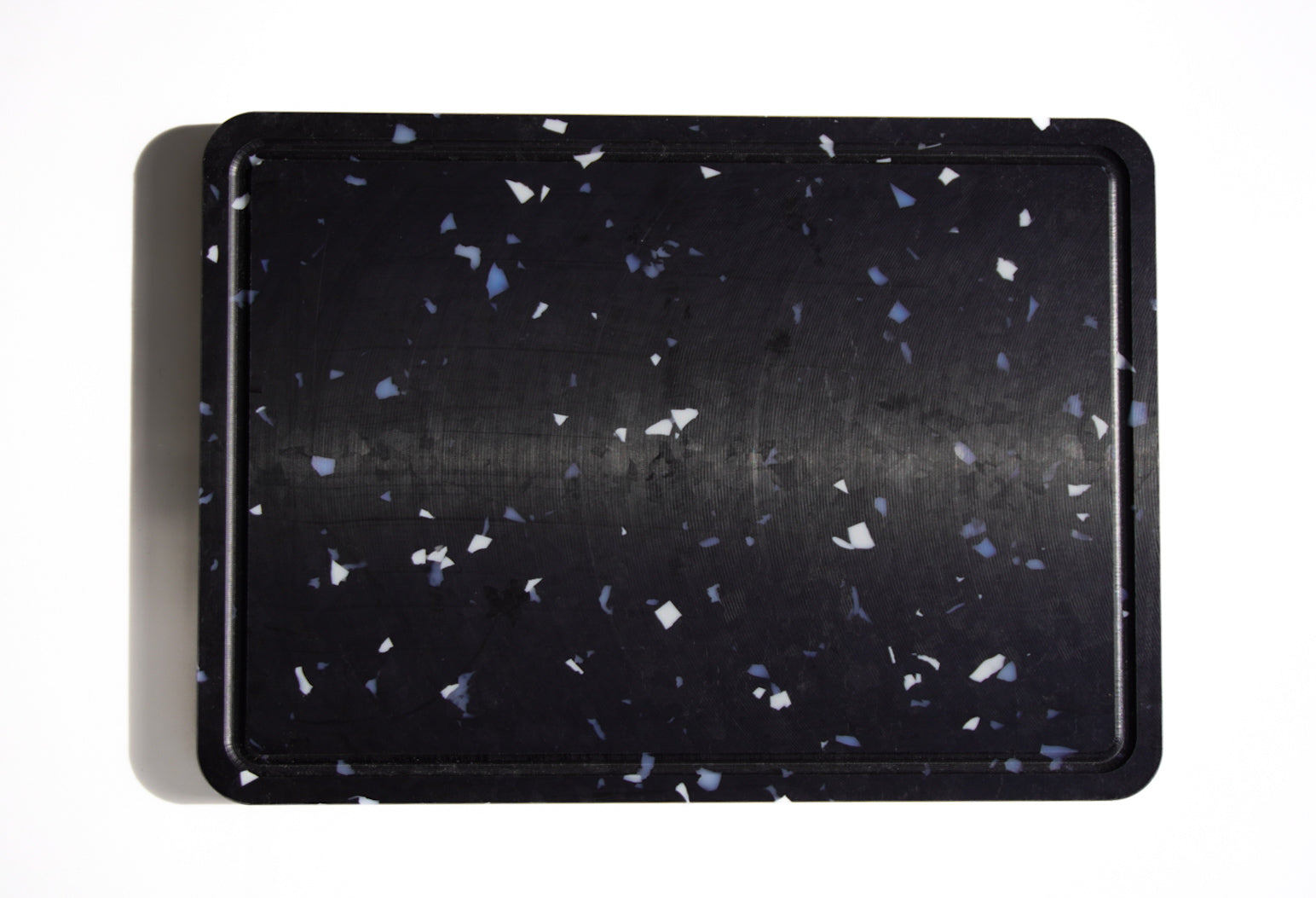Black chopping board with white and grey speckles