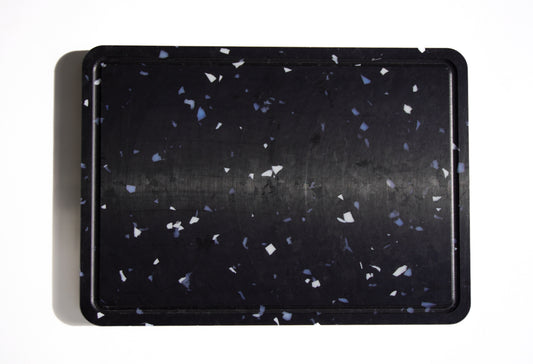 Black chopping board with white and grey speckles