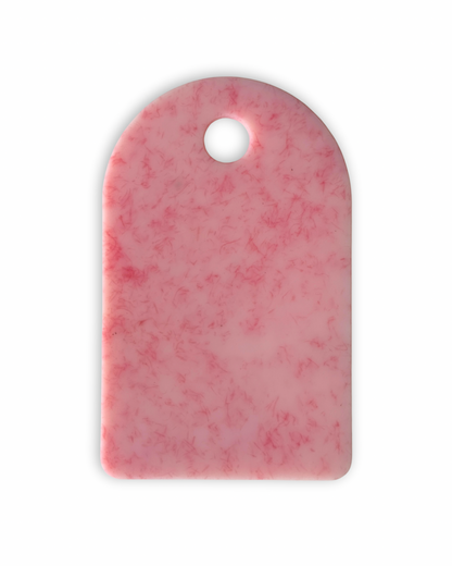 Pink chopping board with round end and hole for hanging
